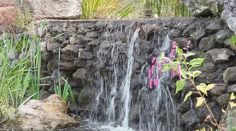 Artificial backwater with a small waterfall Stock Footage 54360447