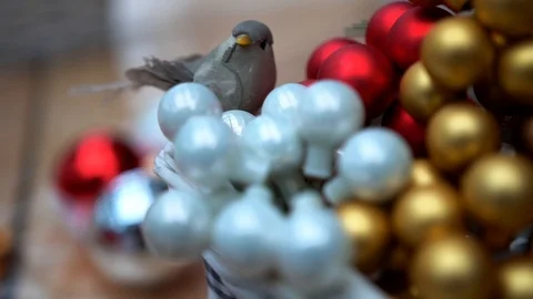Artificial bird on small multicolor glass christmas tree balls, close-up Video stock 89240358