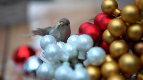 Artificial bird on small multicolor glass christmas tree balls, close-up Stockbeeldmateriaal 89240360