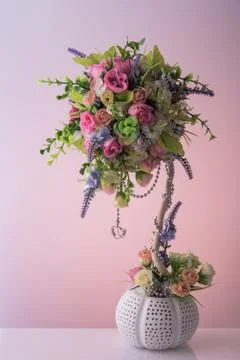 Artificial bouquet of diffirent beautiful small flowers with nice silver chai Stock Photos