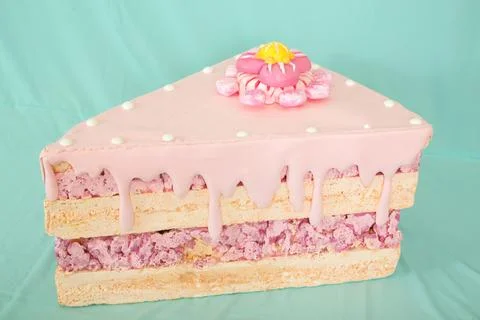Artificial cake slice made from polystyrene foam, featuring pink icing Stock Photos