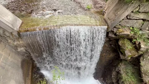 Artificial cascade on the stream Fluela (Flüelabach) or waterfall Flüela Stock Footage 296643049