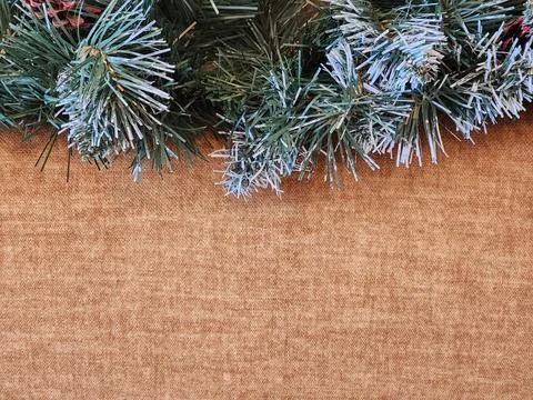 Artificial Christmas tree branches on rough fabric. Artificial tree Stock Photos