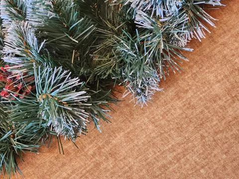 Artificial Christmas tree branches on rough fabric. Artificial tree Stock Photos