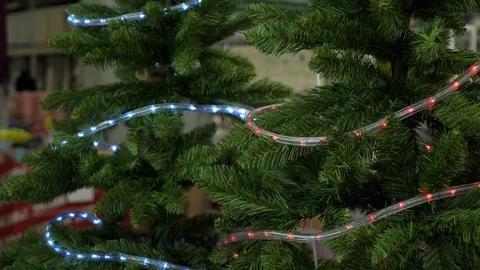 Artificial christmas tree branches with shining garlands Video stock 114645076