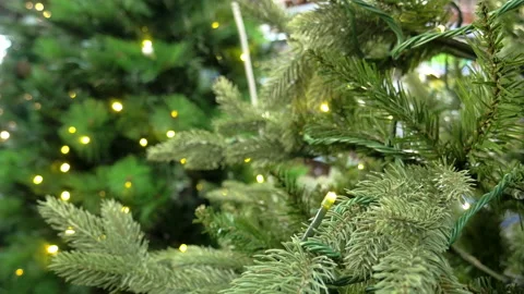An artificial Christmas tree branches with yellow lights blinking Stock Footage 224905044
