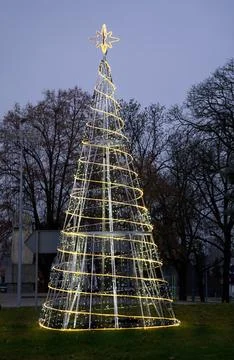 An artificial Christmas tree in the shape of a cone, made of garlands , ins.. Stock Photos