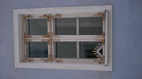 Artificial Christmas triangular candlestick of seven candles on the window Stock Footage 220683317