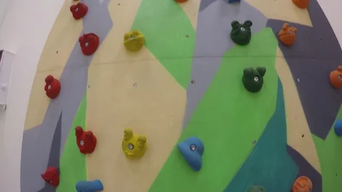 Artificial climbing or bouldering wall at playground game center. Gimbal motion Stock Footage 113903257
