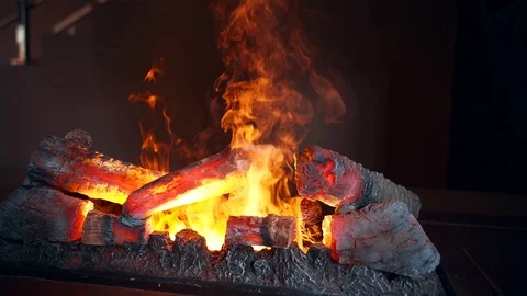 Artificial fire in the fireplace. Fireplace with artificial fire in the interior Video stock 114479897