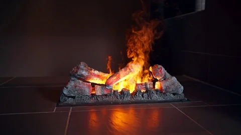 Artificial fire in the fireplace. Fireplace with artificial fire in the interior Video stock 114480056