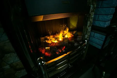 Artificial fire in a stone fireplace Stock Photos