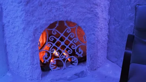 Artificial fireplace with firewood and bonfire in a salt room with blue light Stock Footage 201461185