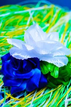 Artificial flower on a substrate of multi-colored thread Stock Photos