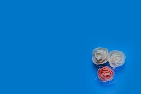 Artificial flowers on a blue background frame for text. copy space one Stock Photos