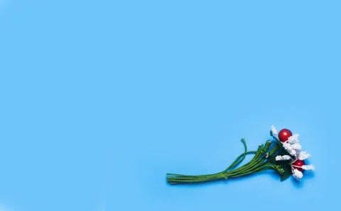 Artificial flowers on a blue background frame for text. copy space one Stock Photos