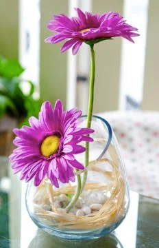 Artificial flowers in jug on the table Stock Photos