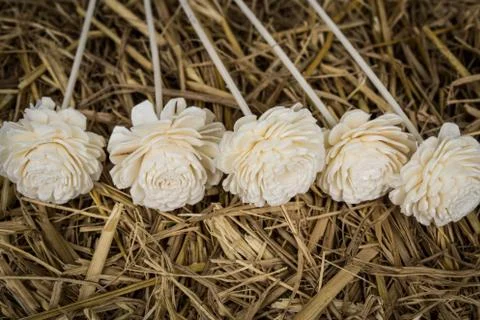 Artificial flowers on straw Foto stock