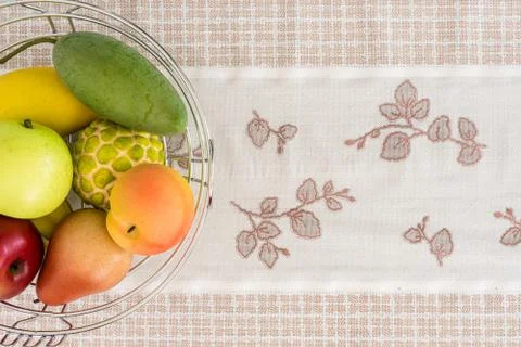 Artificial fruit on patterned fabrics. Stock-Fotos