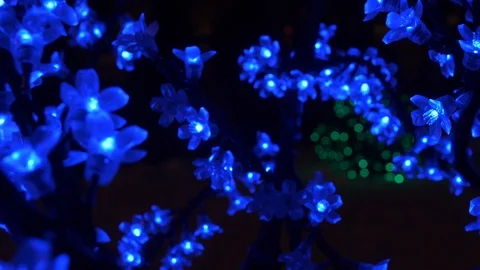 Artificial glowing blue flowers on the tree Stock Footage 119567940
