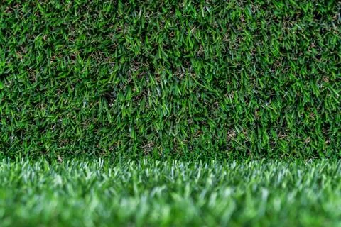 Artificial grass backdrop with selective focus. Stock Photos