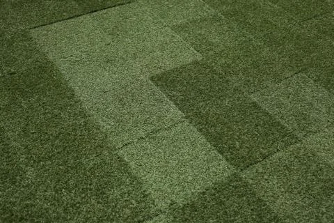Artificial grass tile texture green patchwork surface Stock Photos