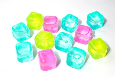 Artificial ice cubes of different colors made of plastic. Isolate. Stock Photos