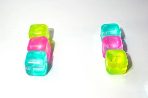 Artificial ice cubes of different colors made of plastic. Isolate. Stock Photos