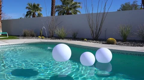 Artificial inflatable balls float in a pool at a Palm Springs home. Stock Footage 67271290
