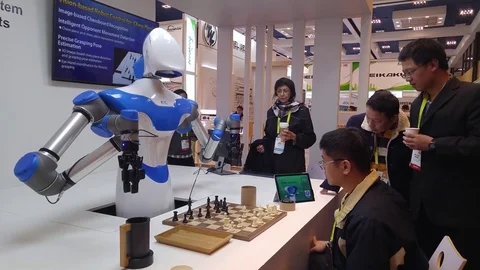 Artificial intelligence computer robot playing chess at CES 2017 trade show Stock Footage 73438147