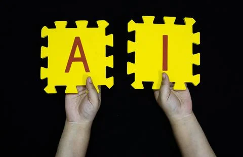 Artificial intelligence concept hands displaying foam alphabet tiles for ai Stock Photos