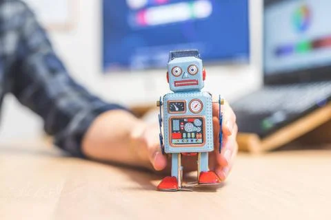 Artificial intelligence concept: Toy robot on office desktop. Metaphor for... 스톡 사진