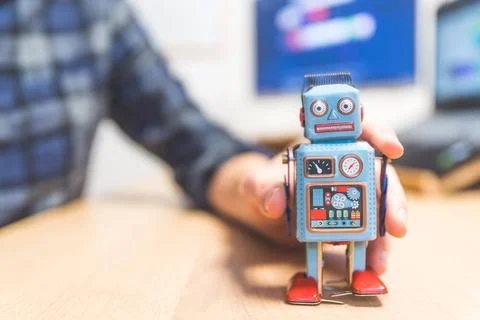 Artificial intelligence concept: Toy robot on office desktop. Metaphor for... 스톡 사진