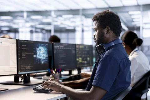 Artificial intelligence engineer in data center checks for performance issues Stock Photos