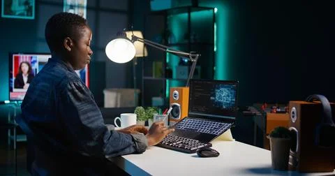 Artificial intelligence engineer working from home using notebook Stock-Fotos