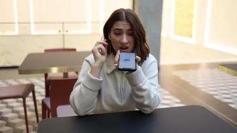 Artificial intelligence receives angry complaint from young woman indoors Video stock 323738657