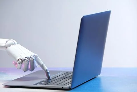 Artificial intelligence. Robot hand with laptop on table against light grey.. Stock Photos