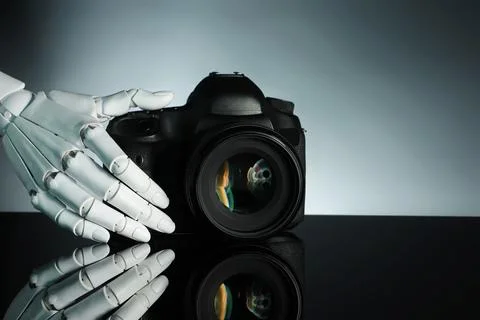 Artificial intelligence. Robot hand with photo camera against grey backgrou.. Stock Photos
