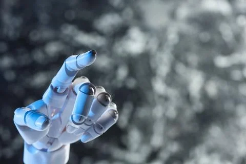 Artificial intelligence. Robot hand pointing at something on grey blurred b.. Stock Photos
