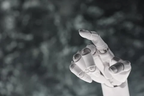 Artificial intelligence. Robot hand pointing at something on grey blurred b.. Stock Photos