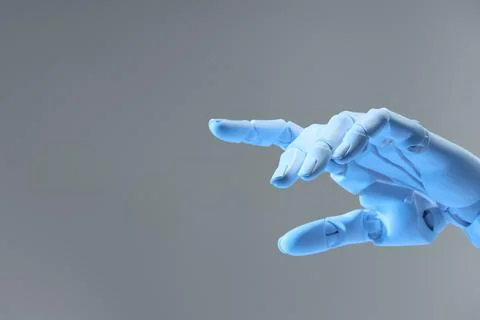 Artificial intelligence. Robot hand pointing at something on grey backgroun.. Stock Photos