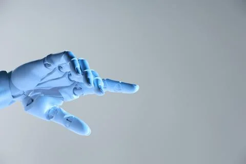 Artificial intelligence. Robot hand pointing at something on grey backgroun.. Stock Photos