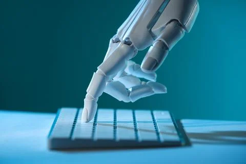 Artificial intelligence. Robot hand using keyboard at table in blue light, .. Stock Photos