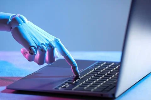 Artificial intelligence. Robot hand using laptop on table in neon lights, c.. 库存照片