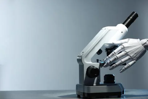 Artificial intelligence. Robot hand working with microscope at table agains.. Stock Photos