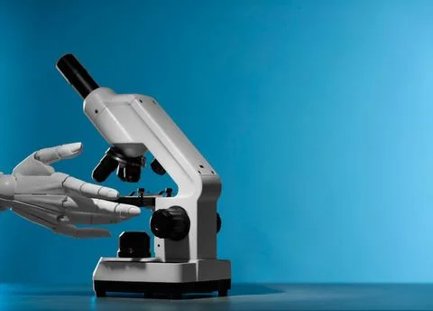 Artificial intelligence. Robot hand working with microscope at grey table a.. Stock Photos