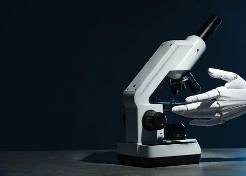 Artificial intelligence. Robot hand working with microscope at grey table a.. Stock Photos