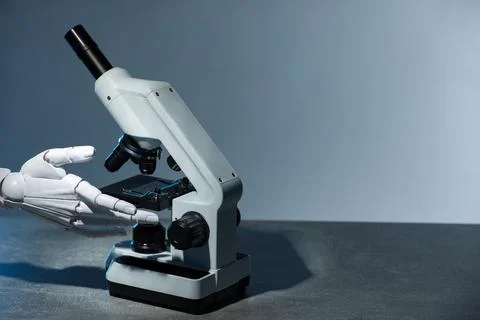 Artificial intelligence. Robot hand working with microscope at table agains.. Stock Photos