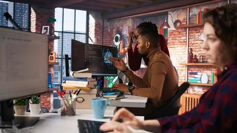 Artificial intelligence startup coworkers doing brainstorming, optimizing code Stock Photos