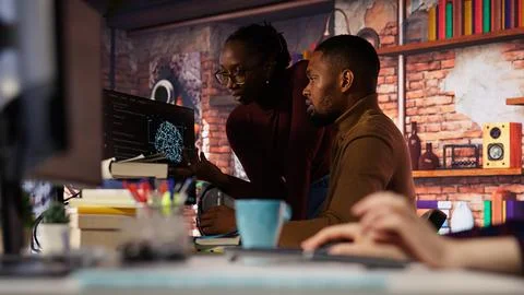 Artificial intelligence startup coworkers doing brainstorming, optimizing code Stock Photos